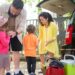 Cheerful family preparing car for a day trip in sunny Portugal.